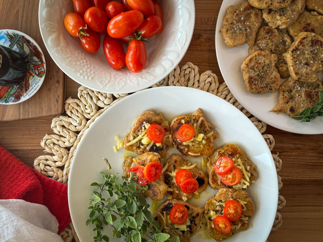 sourdough fry bread rounds with tomato, mozzarella, oregano, and olive oil
