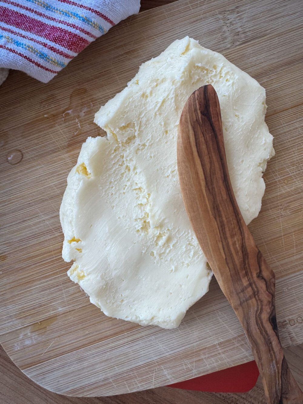 Spreading homemade cultured butter organic cultured cream with olive oil