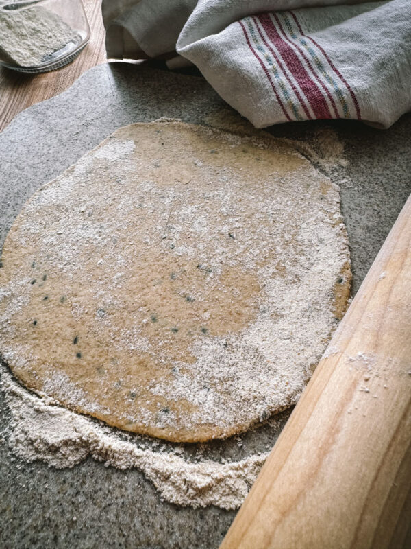 whole wheat einkorn flatbread rolled out on a cutting board