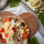 sourdough einkorn flatbreads topped with chicken, cheese, and fermented vegetables