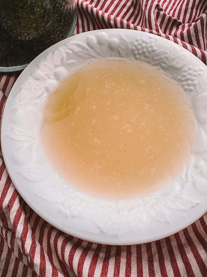 chicken broth in a dinner bowl