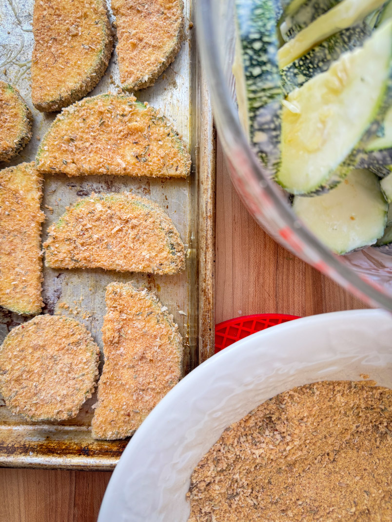 Putting einkorn breadcrumbs on zucchini slices