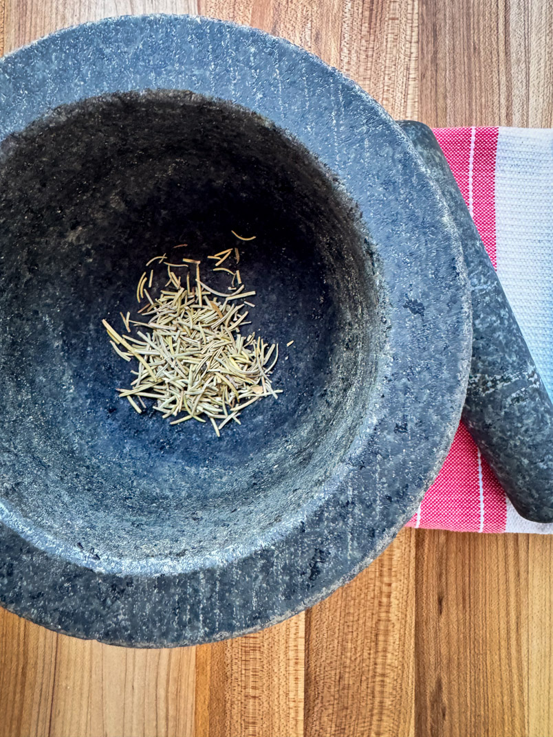 Mortar and Pestle and rosemary leaves