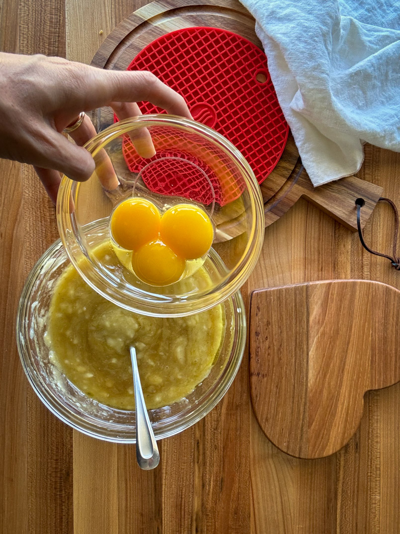 adding eggs to a healthy olive oil cake