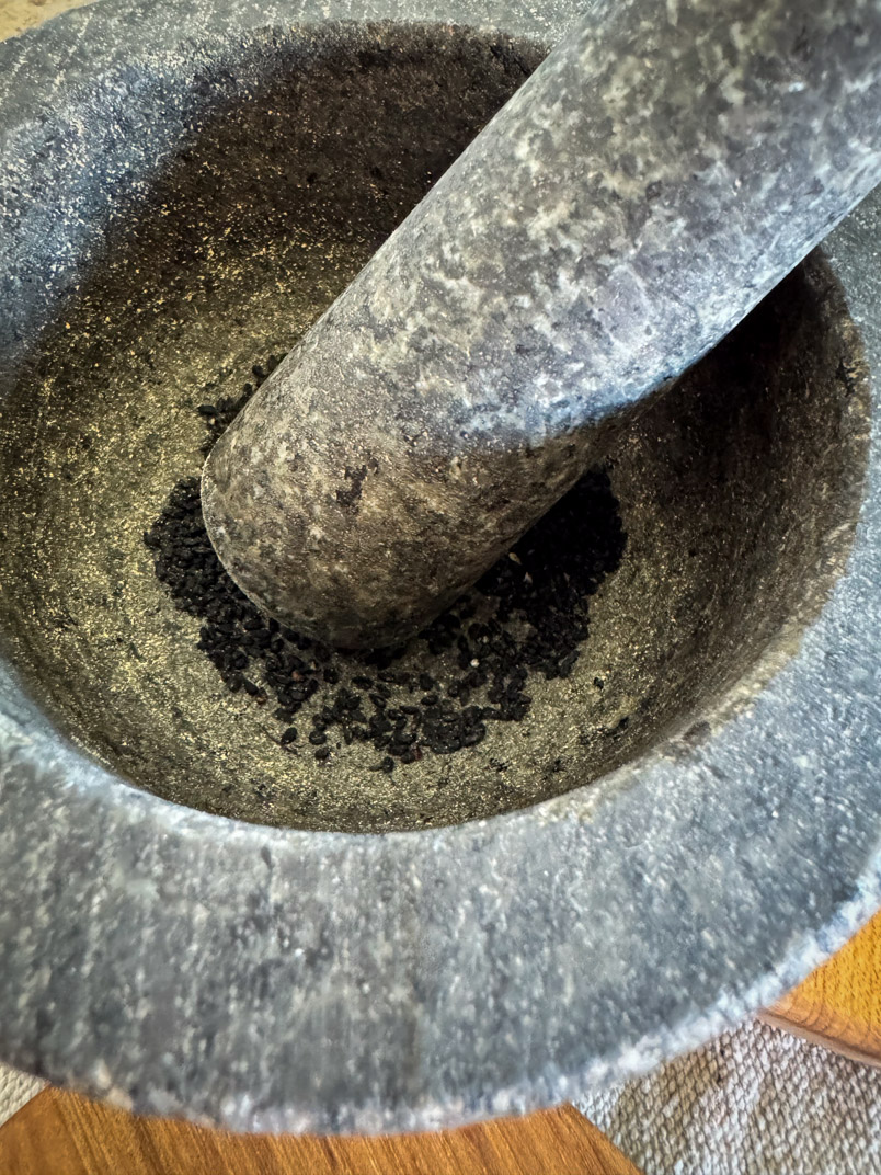 black seeds in a mortar and pestle