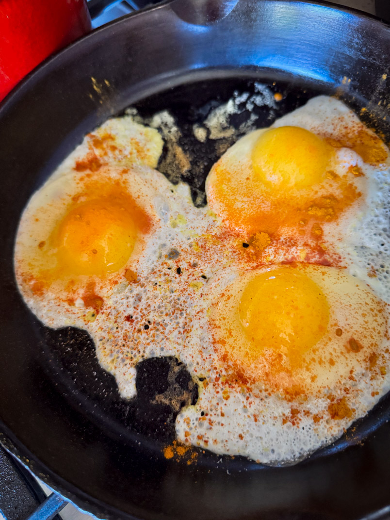 fried eggs in a cast iron frying pan