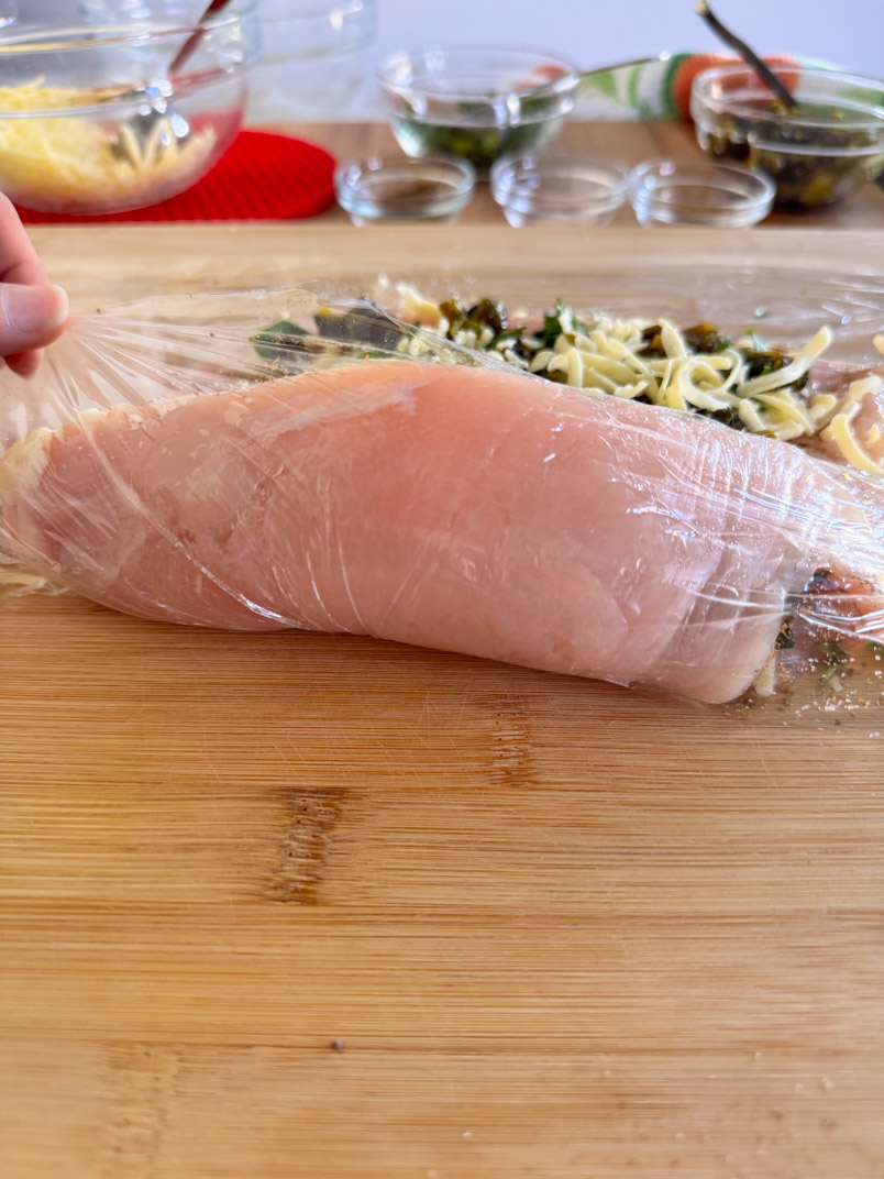 rolling a chicken breast for a healthy chicken dinner rolling a chicken breast for a healthy chicken dinner