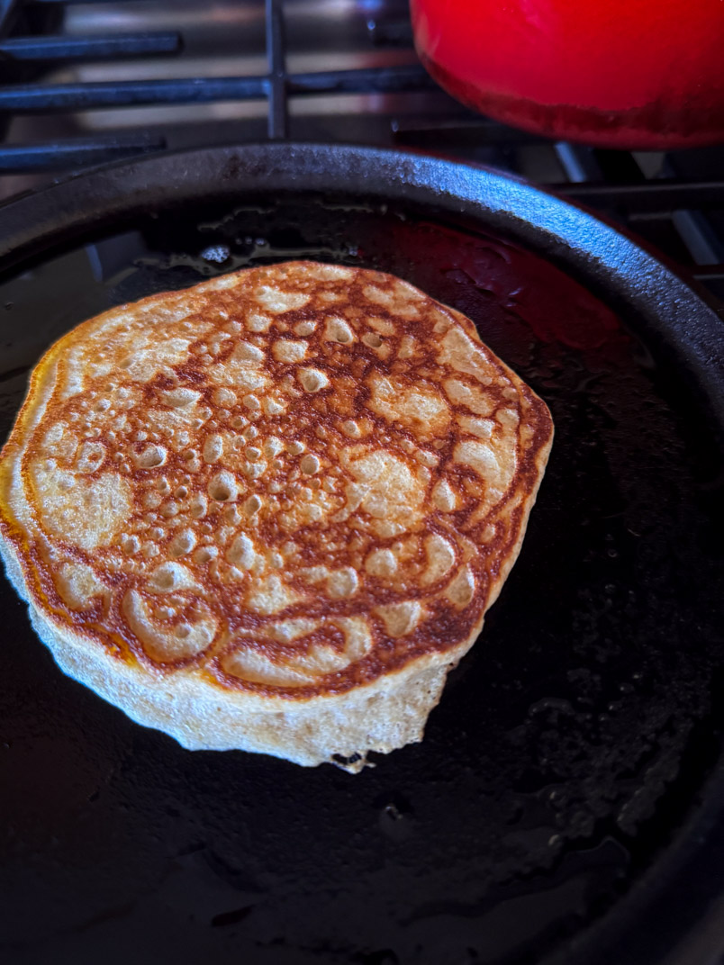 fresh milled einkorn wheat pancakes on a cast iron griddle