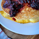 einkorn pancakes with fried eggs and blackberries