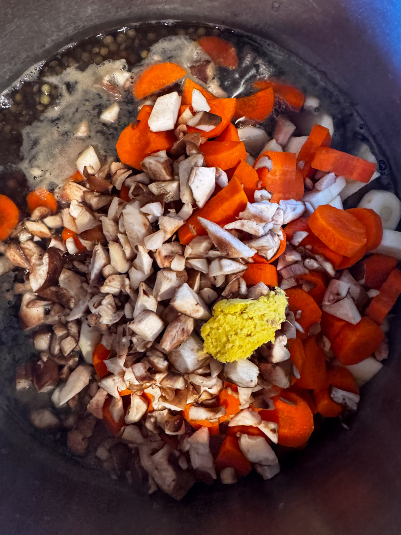 cooking lentil, chicken, and vegetable soup