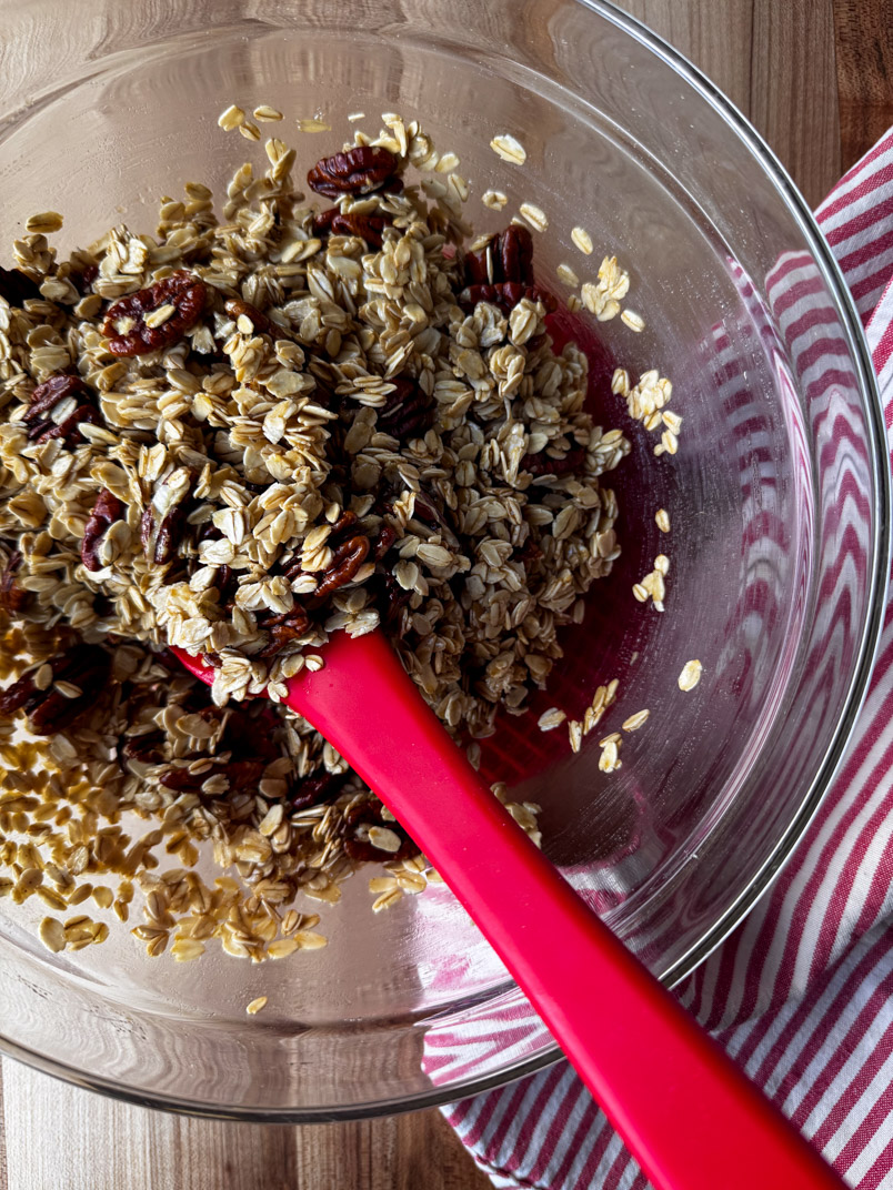stirring maple pecan granola stirring maple pecan granola