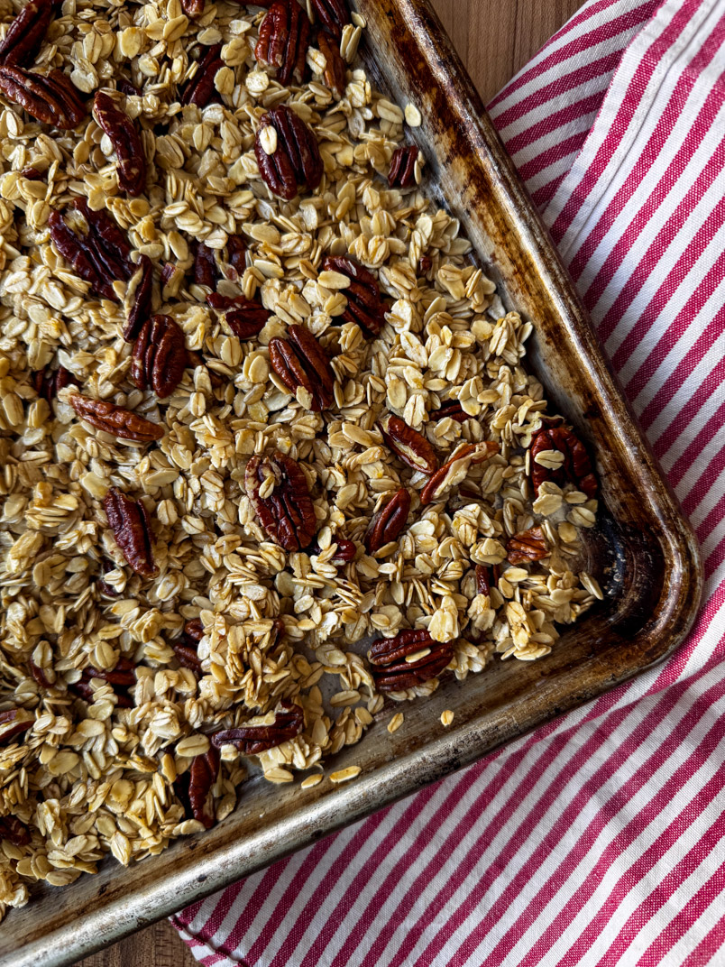 homemade granola on baking sheet homemade granola on baking sheet