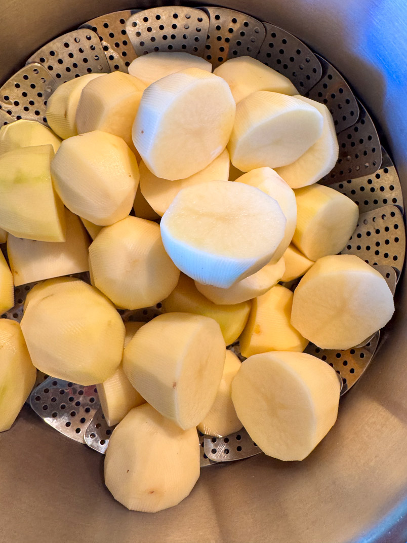 potatoes in a steamer basket