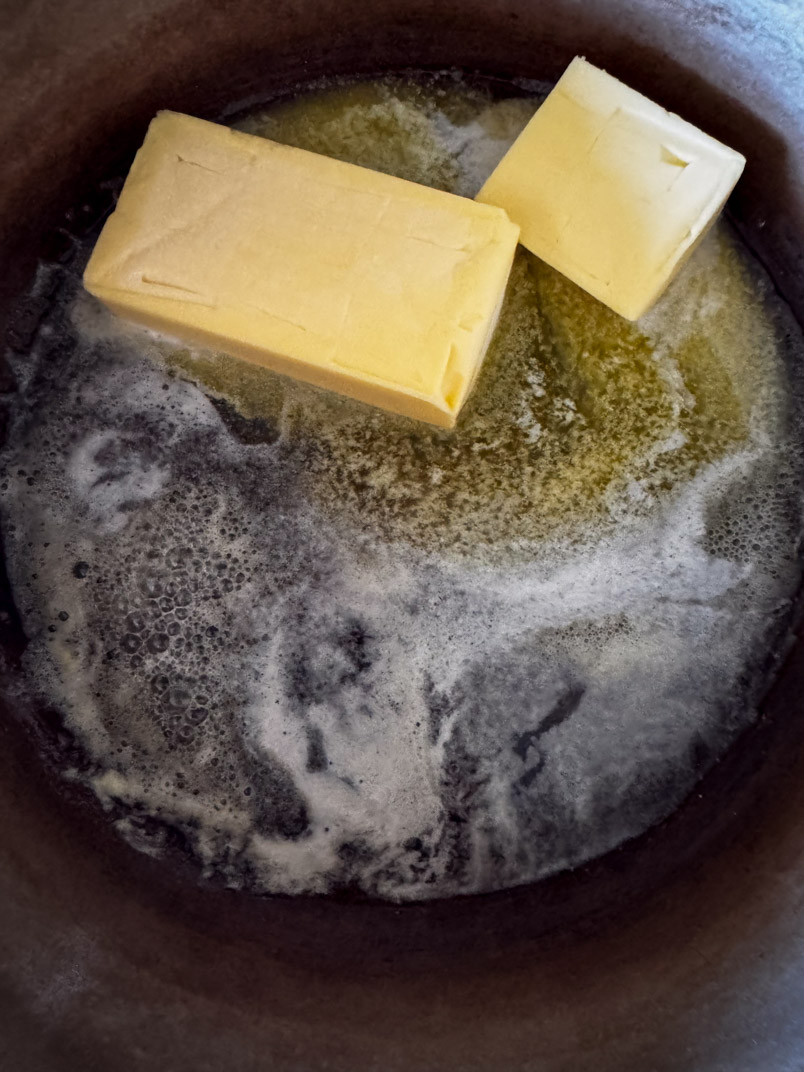 melting butter in thanksgiving dressing pan