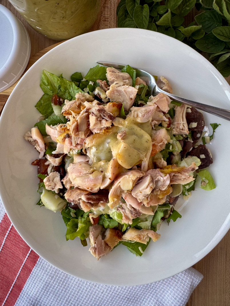 chopped romaine salad, arugula salad, and protein toppings