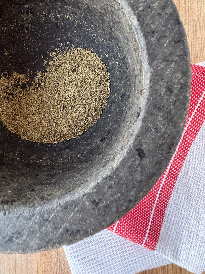 grind rosemary in mortar and pestle